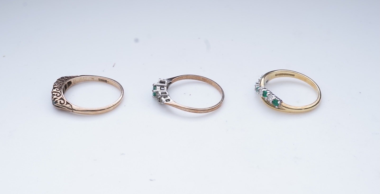 Three emerald and diamond rings